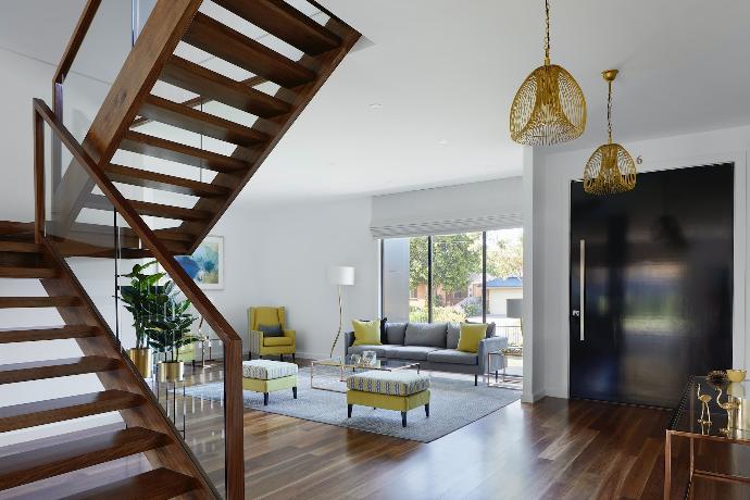 brown wooden spiral staircase near gray couch